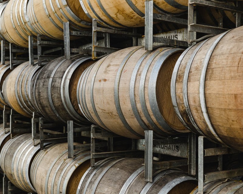 Oak barrels inside a McLaren Vale winery cellar